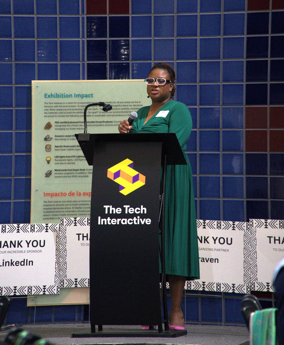 A photograph of Shonda Goward at a lectern displaying the sign, Black Engineers Week